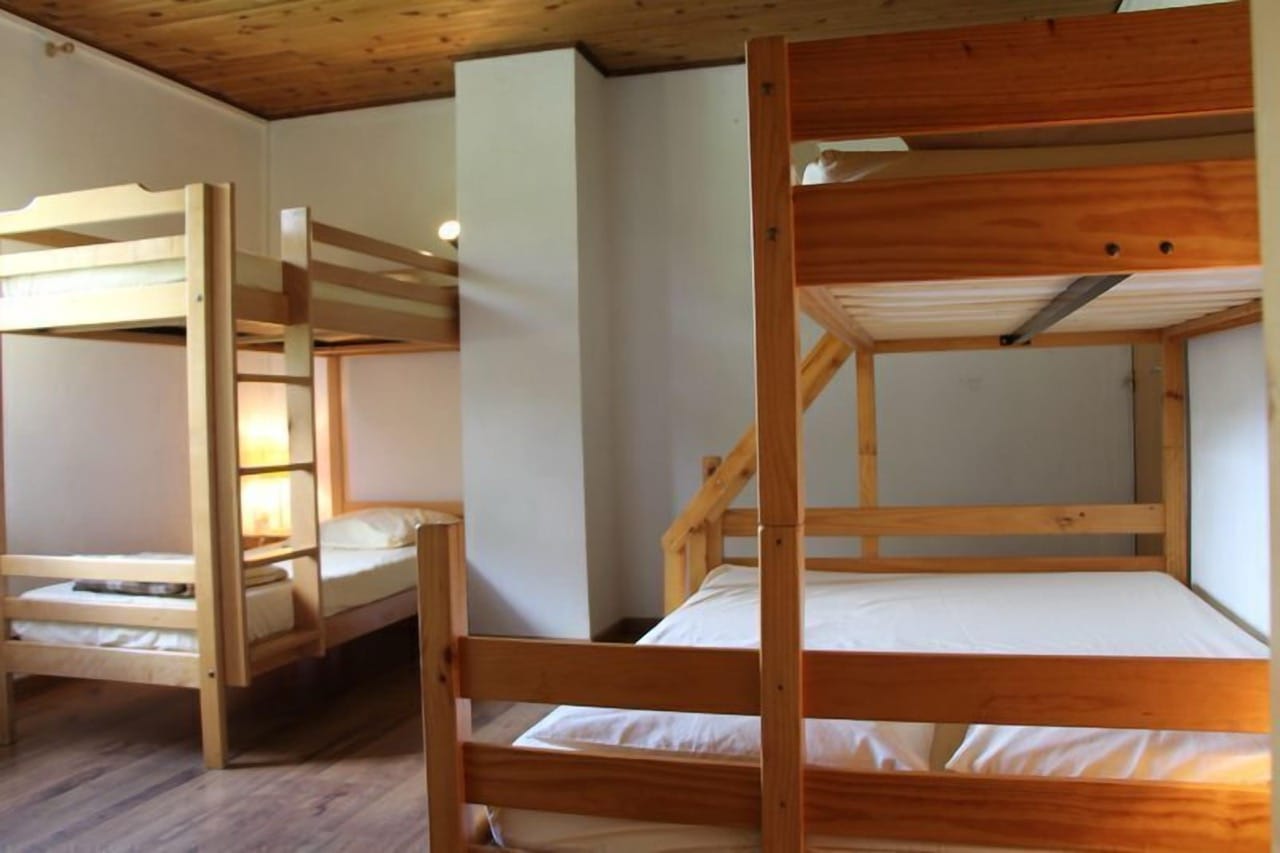 Two wooden frame double deck beds at Gite - Auberge Le Chamois Col d'Ornon with simple rustic style