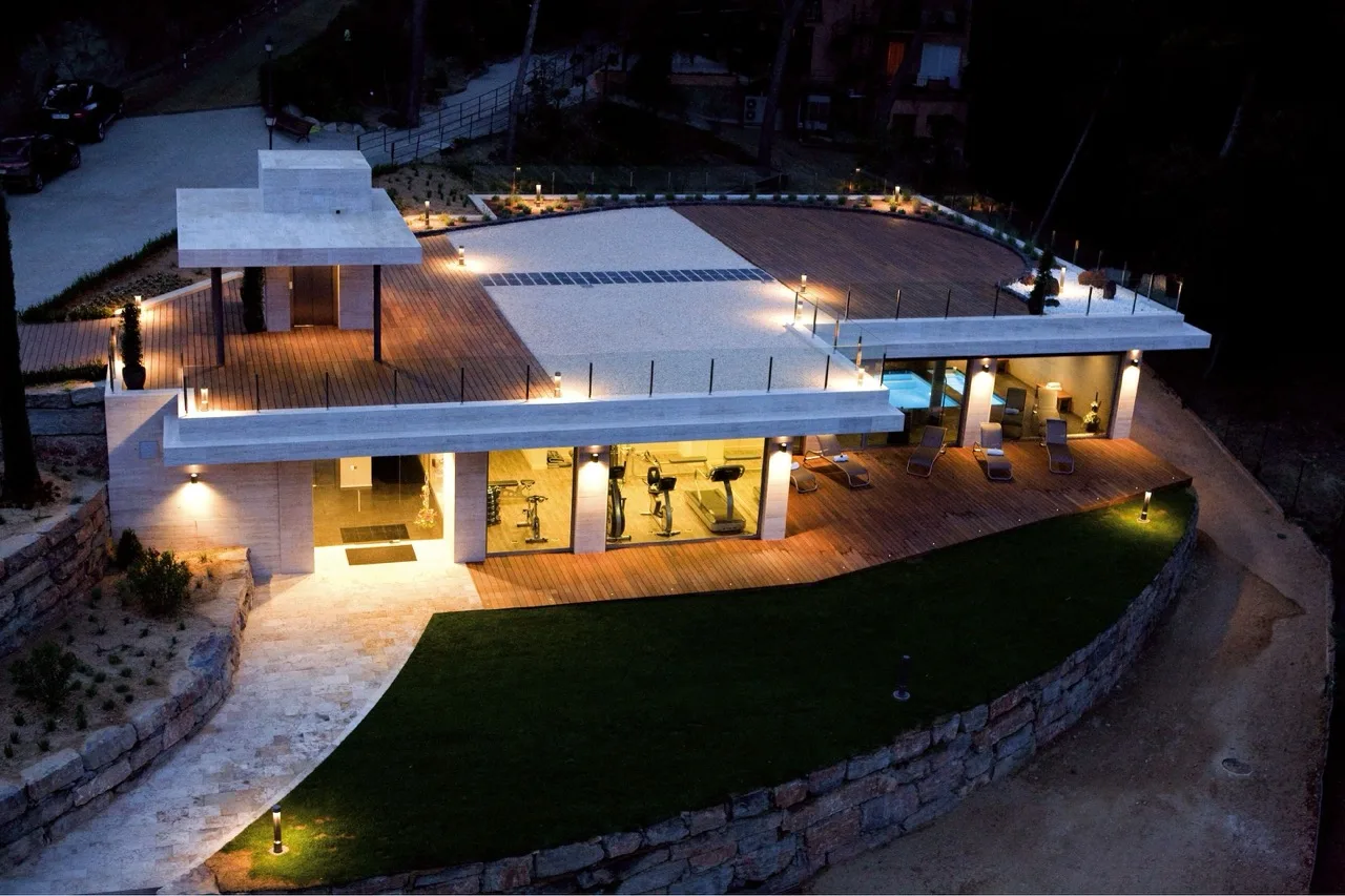 Aerial night view of Hotel Santa Marta in Lloret de Mar, illuminated against a dark coastal landscape