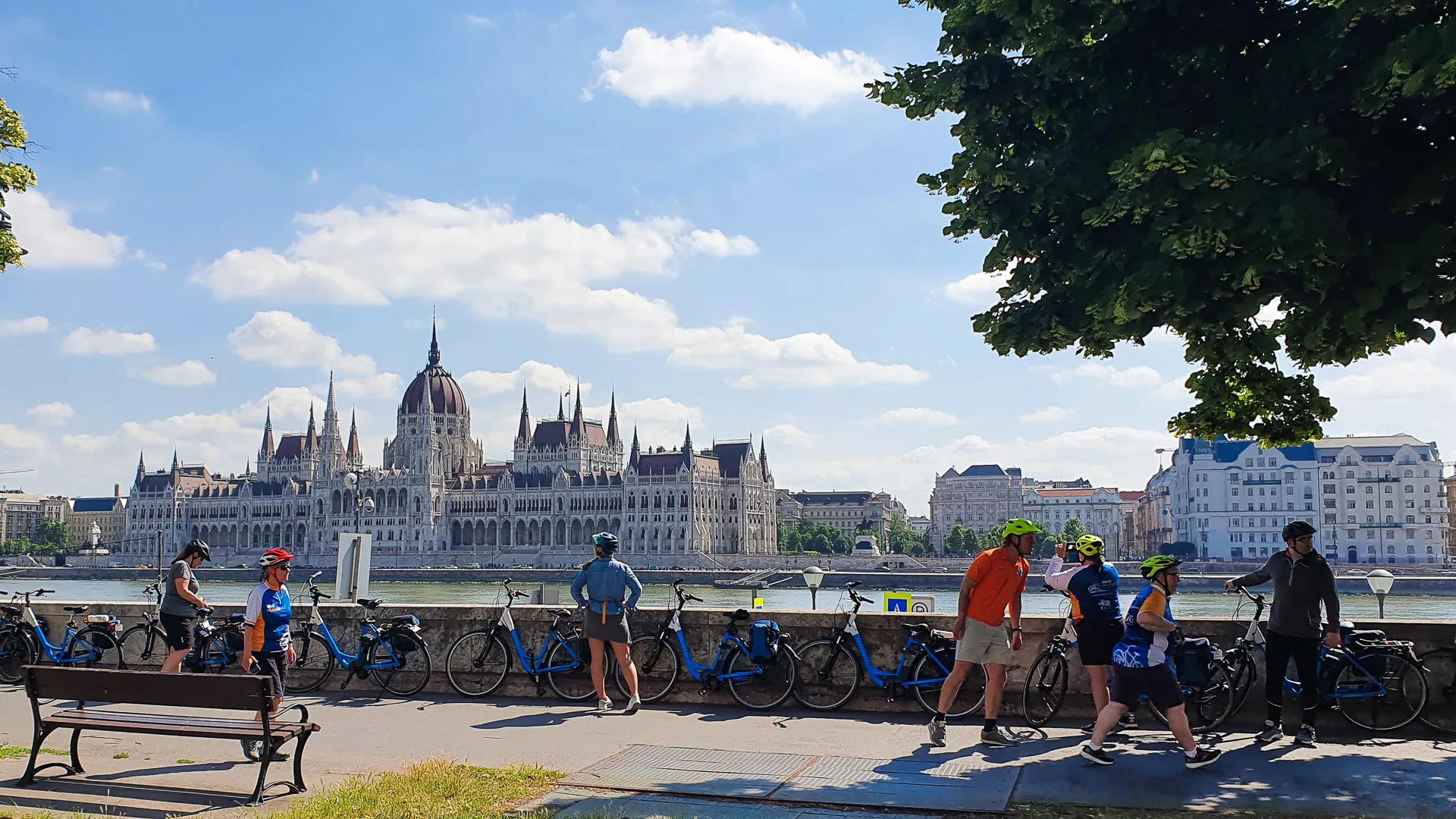 Cyclists admiring the view of the Houses of Parliament in Budapest city
