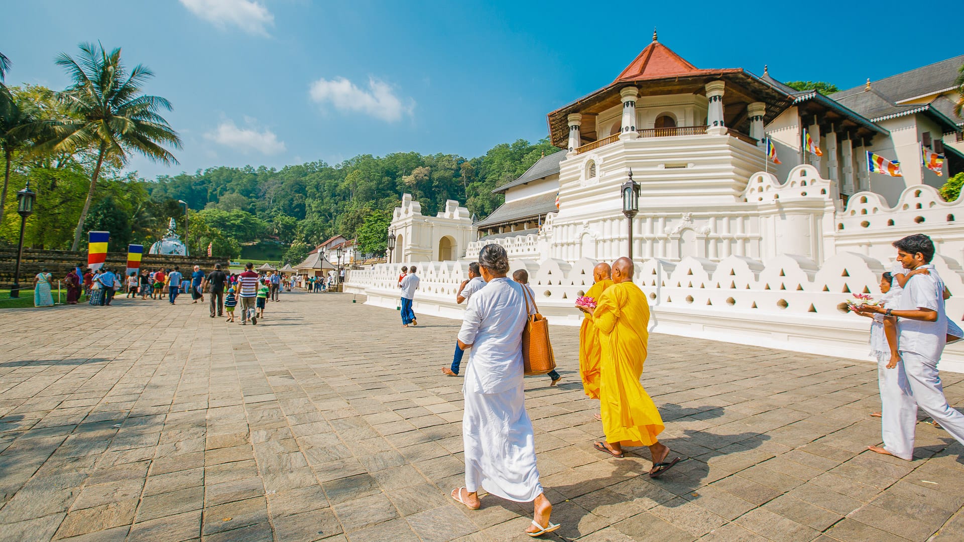People walking towards the Temple of the Sacred Tooth Relic in Kandy, Sri Lanka