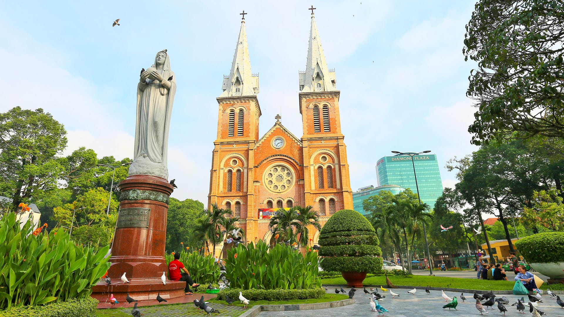Notre Dame Cathedral in Ho Chi Minh City with statue and gardens in front