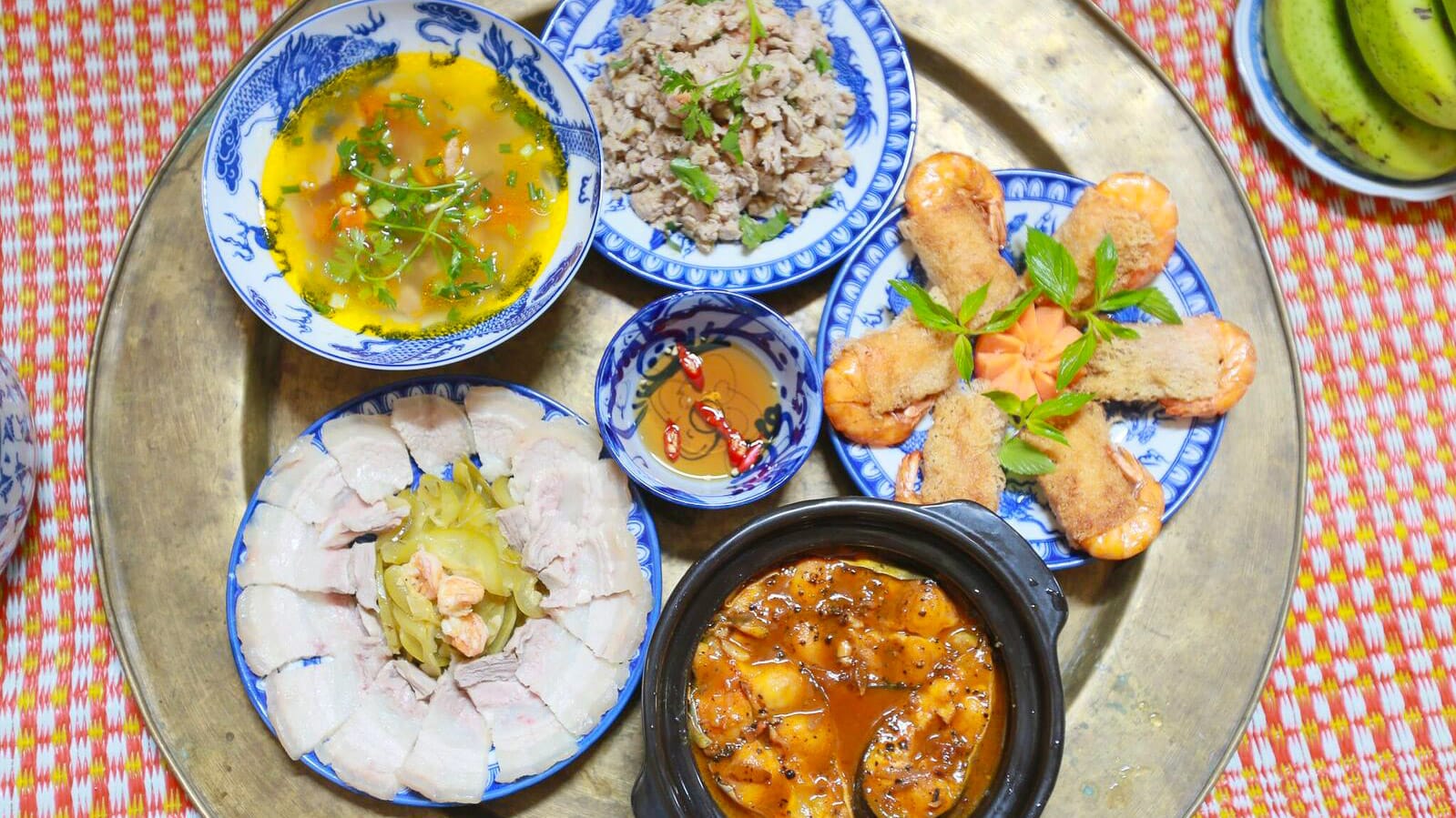 Traditional Vietnamese dishes from Hue served on a tray with colourful bowls