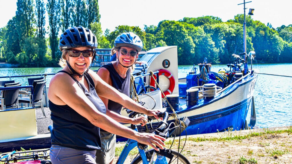 Happy cyclists infront of a barge in france