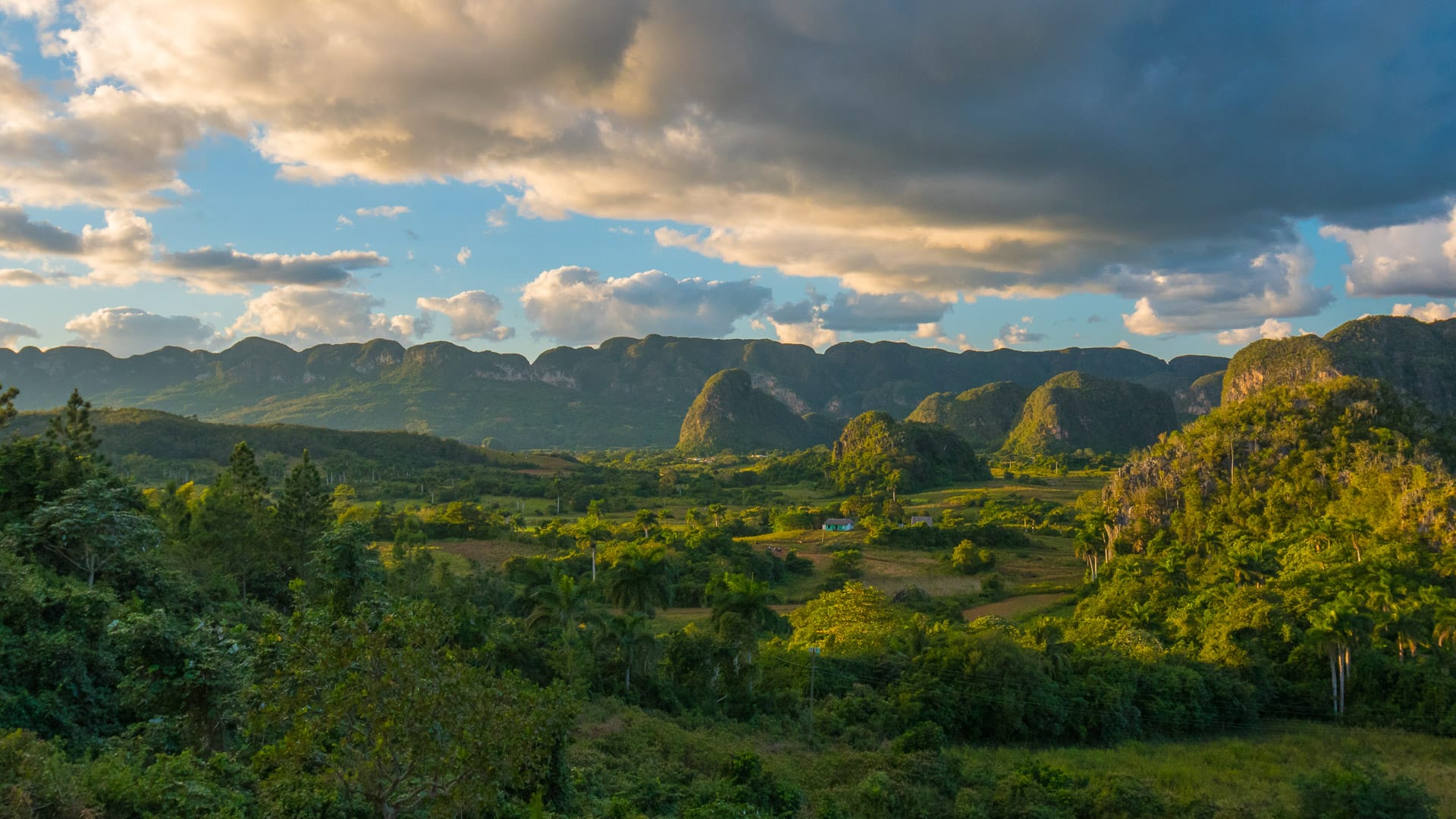 Golden sunset casting shadows across the rolling green hills in Cuba