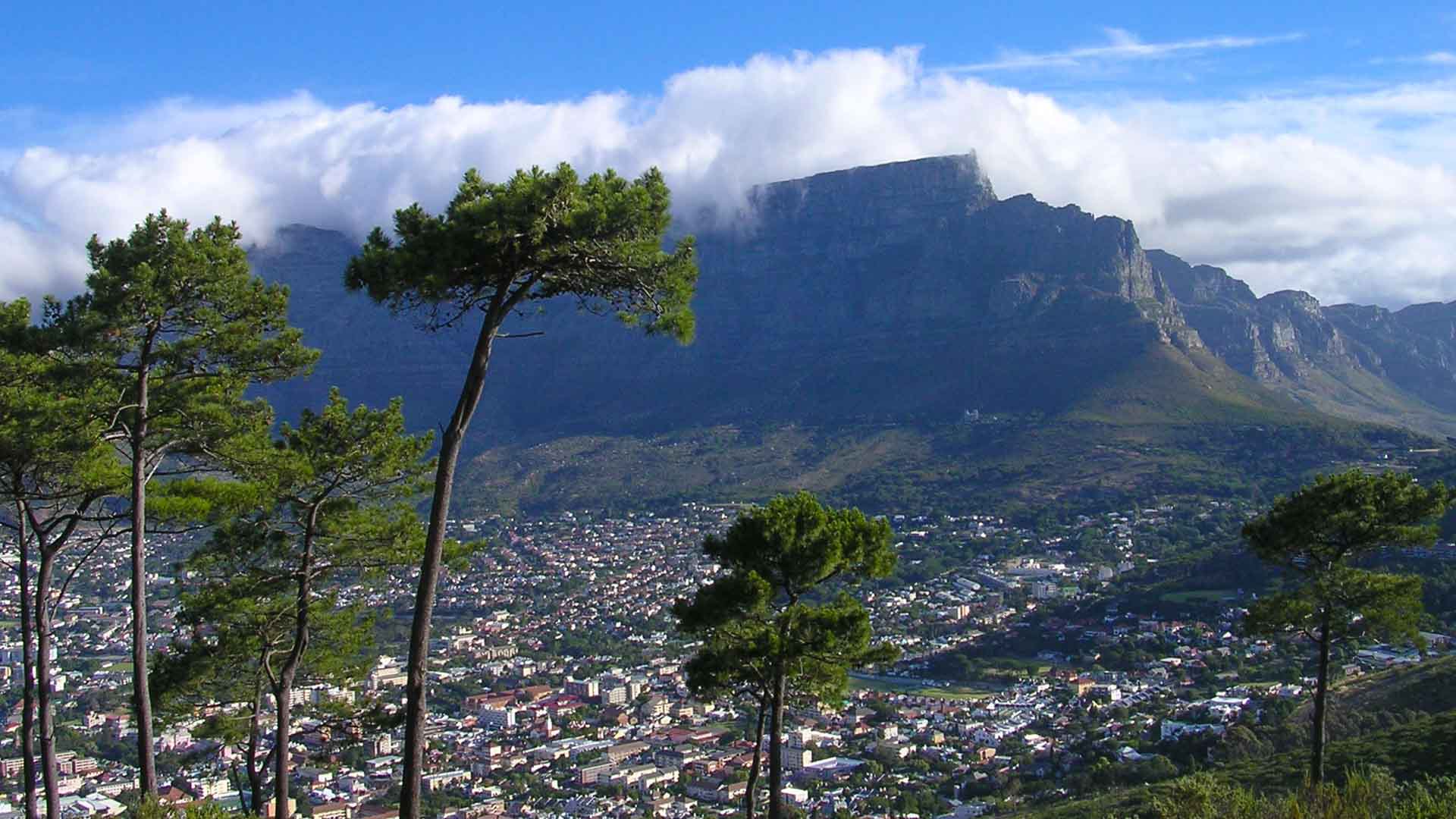 View of Cape Town from Signal Hill with Table Mountain in the background on a partly cloudy day
