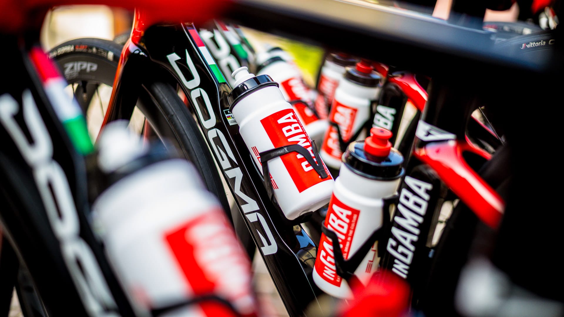 Close-up of inGamba cycling bottles mounted on Pinarello bikes during a ride