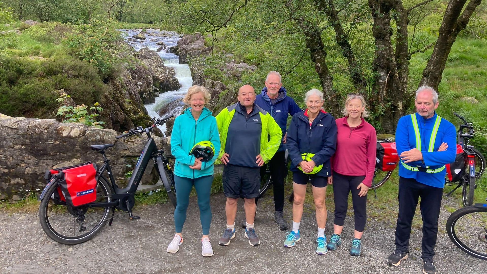 Cyclists posing by a stream in the Duddon Valley, Lake District tour