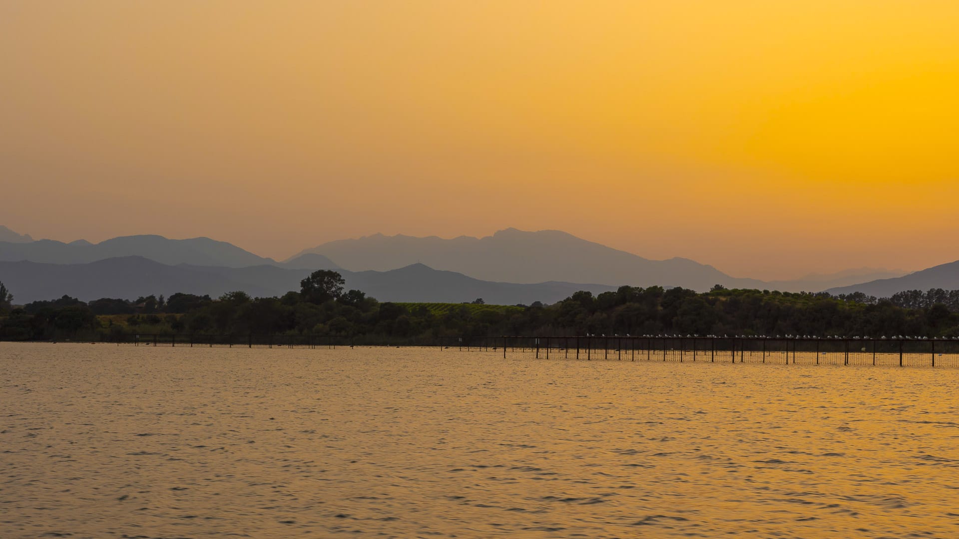 Etang de Diana in Corsica glowing under a warm golden sunset