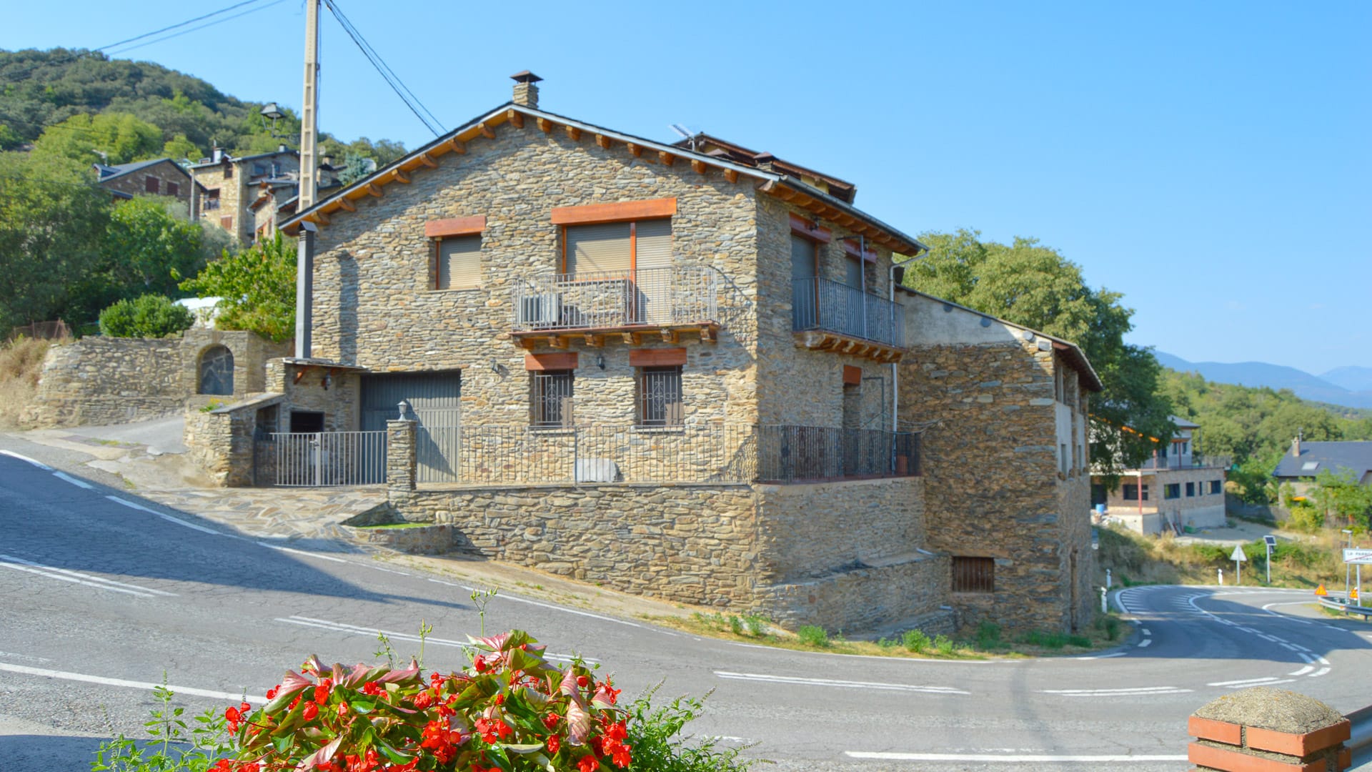 Traditional stone house on a corner in Alp village, Spanish Pyrenees