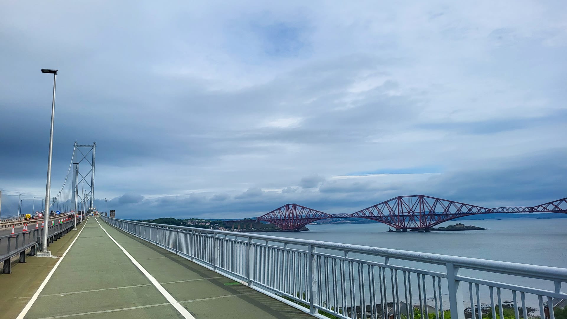 Cycle path on bridge with view of the red Forth Bridge in Scotland