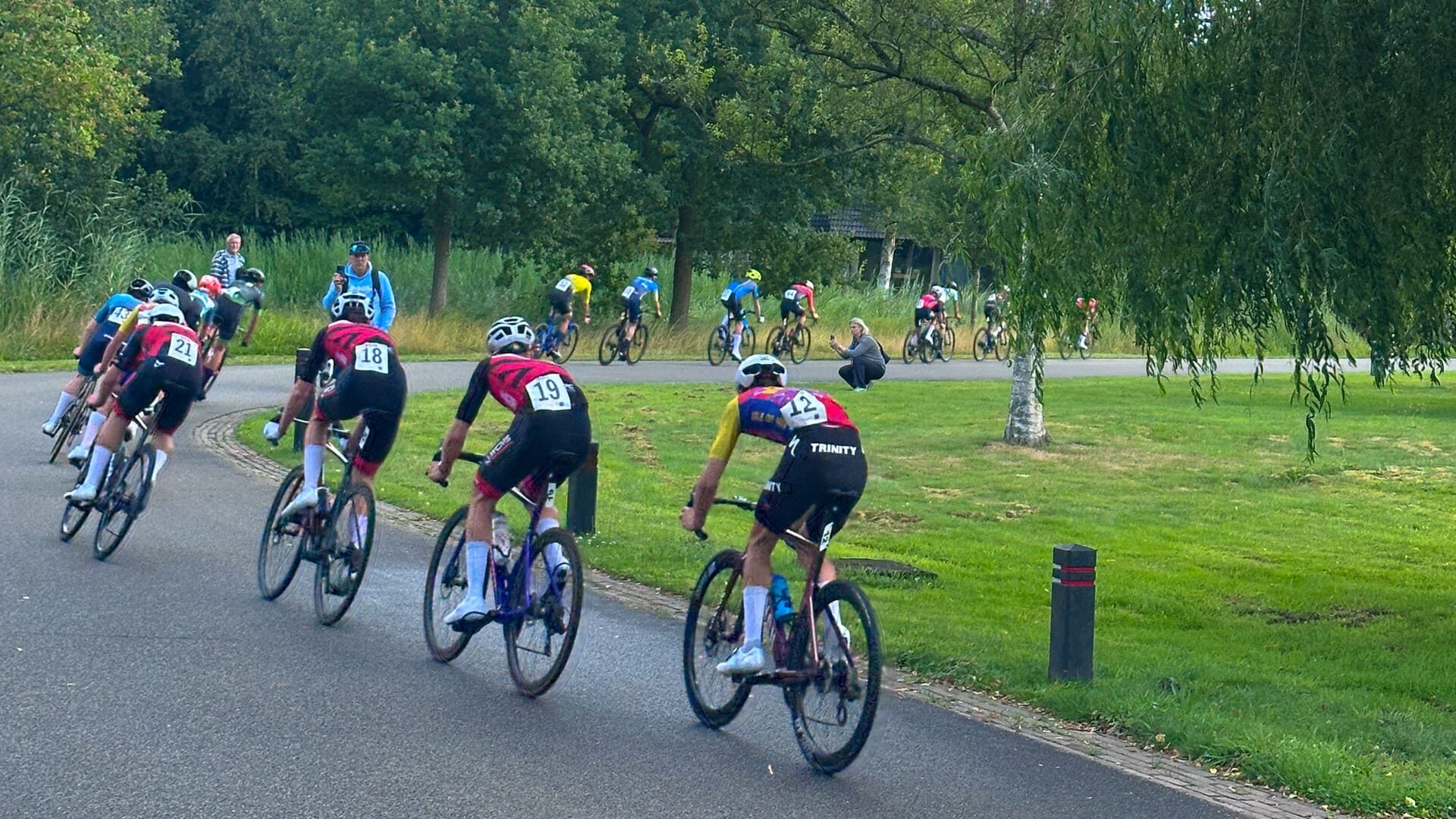 Cyclists racing around a bend during the criterium near Assen 2025