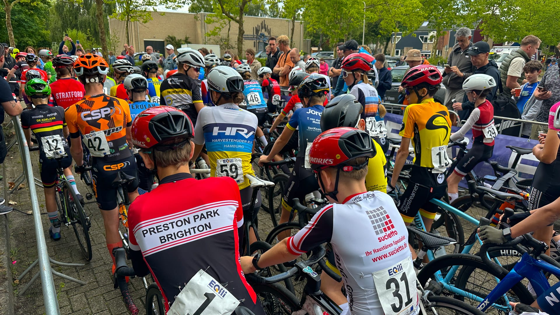 Young cyclists gathered at the start pens before a junior criterium race near Assen