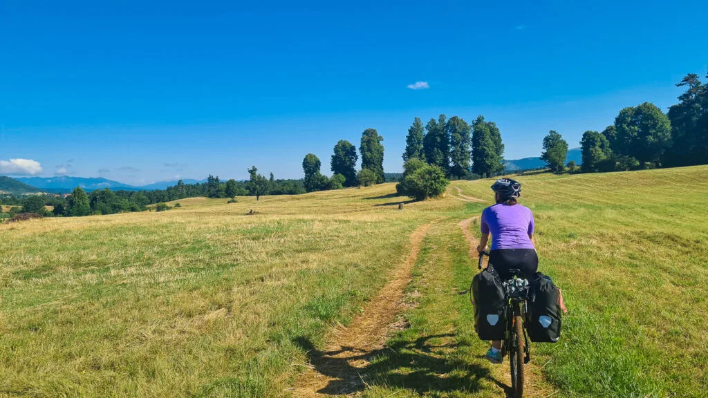 Cyclist riding through the Pivka Valley