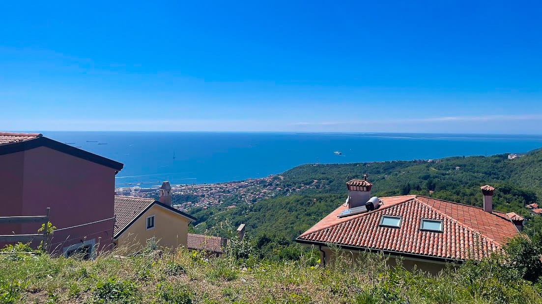 First view over rooftops to Adriatic Sea and Trieste coastline in Italy