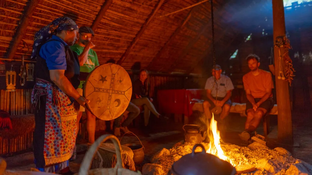 Mapuche hosts share traditions inside ruka around warm central fire