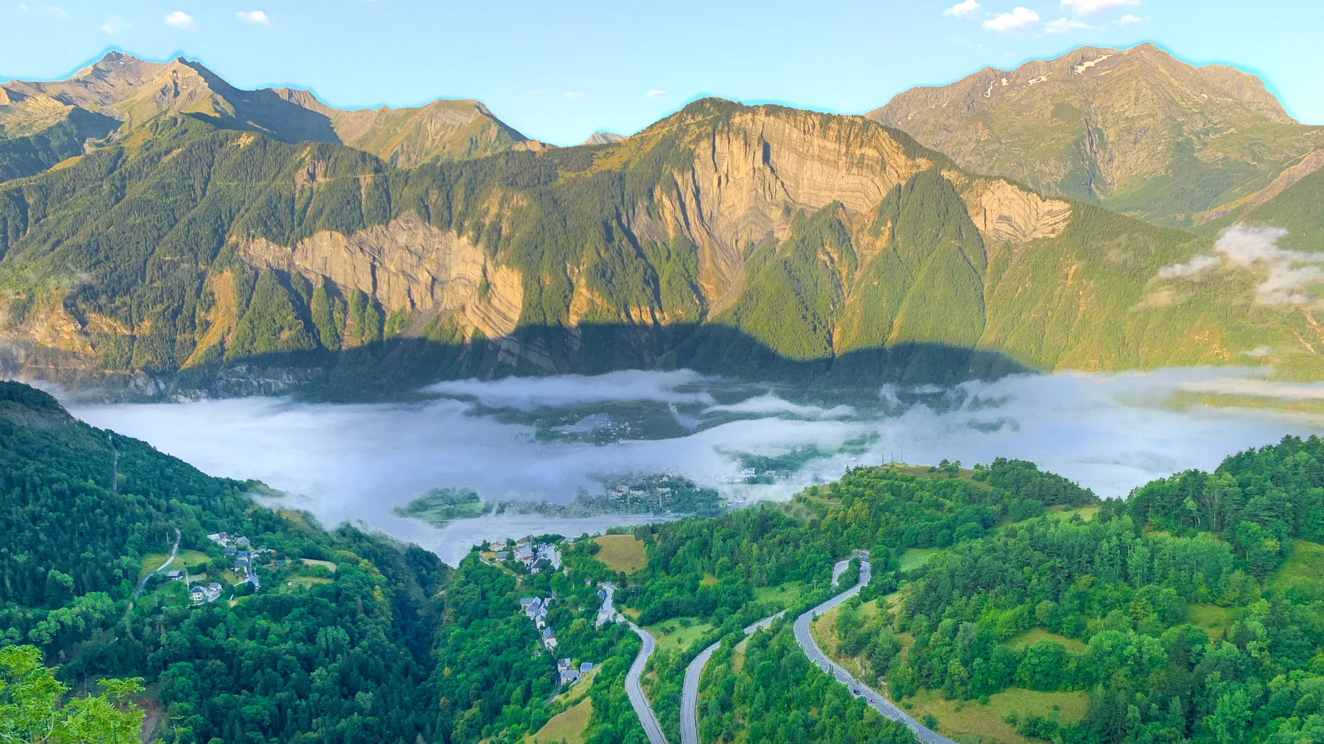 Aerial view over Bourg d’Oisans and Alpe d’Huez hairpins in summer Alps
