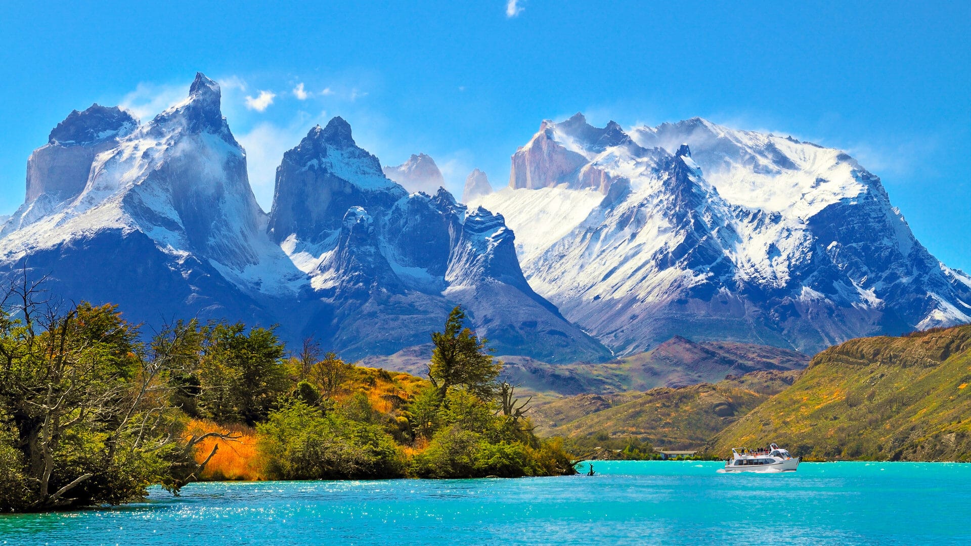 Bright blue lake with Torres del Paine peaks behind