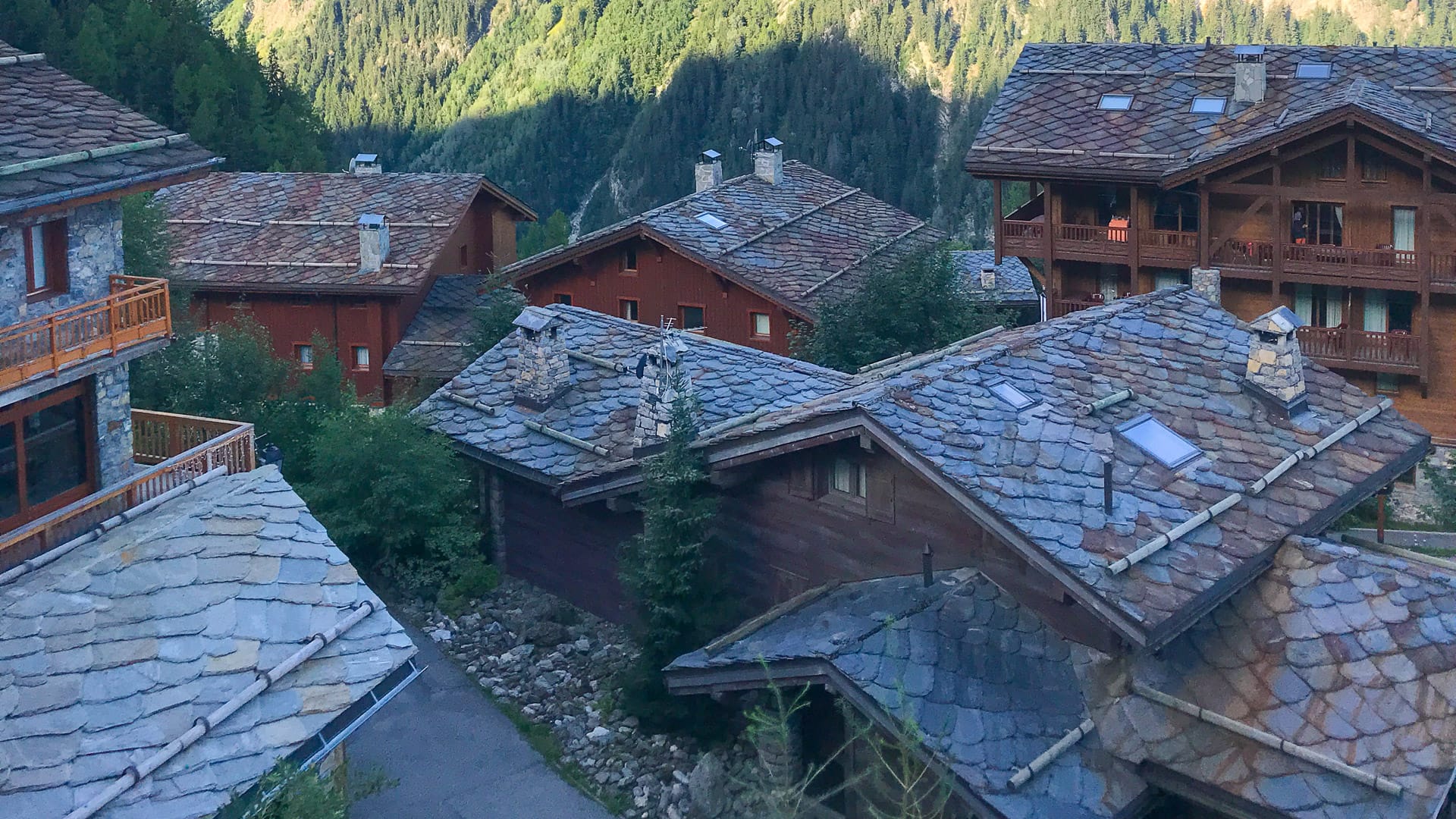 Scenic view of traditional alpine chalets with stone rooftops nestled in the mountains at Sainte Foy Tarentaise