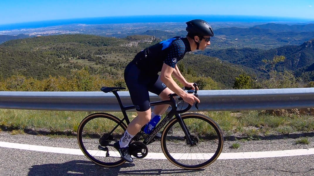 Cyclist with spectacular backdrop to sea