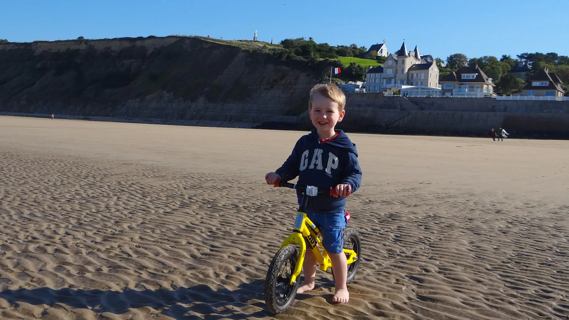 Child on beach in Normandy, France