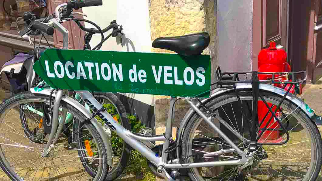 A bike parked up by a french sign