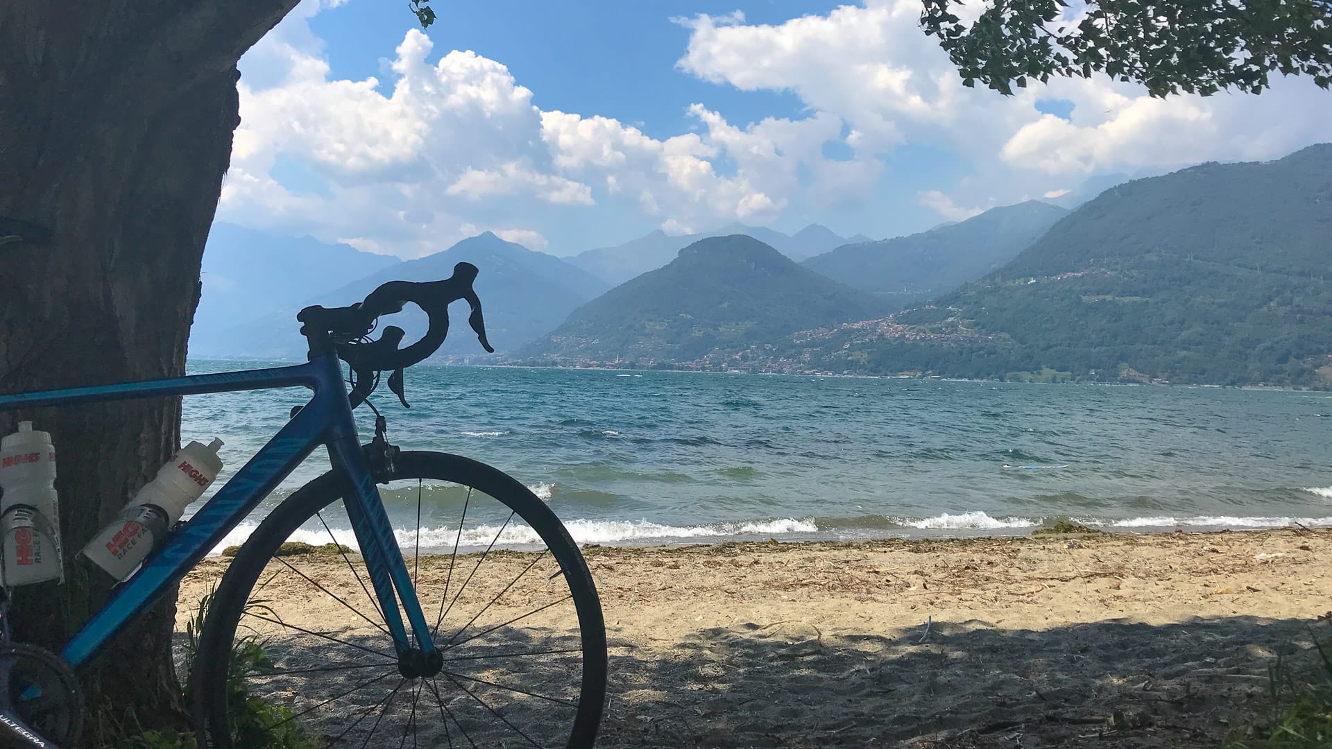 Cycling Lake Como with bike on beach at Lake Como
