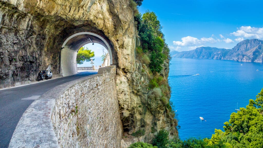 Tunnel above sea in Amalfi coast, an amazing place to go cycling in Italy