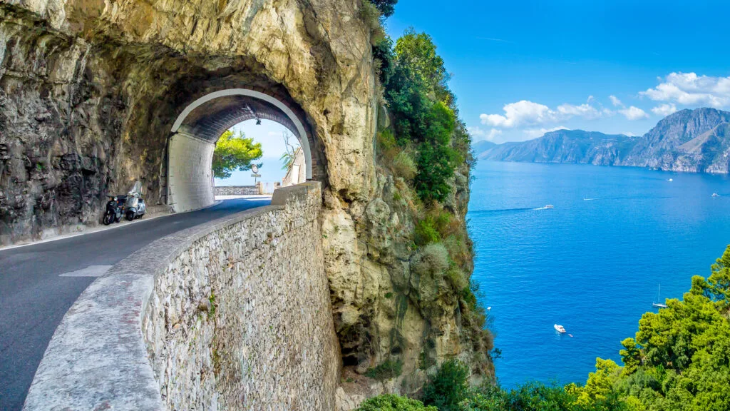 Tunnel above sea in Amalfi coast, an amazing place to go cycling in Italy