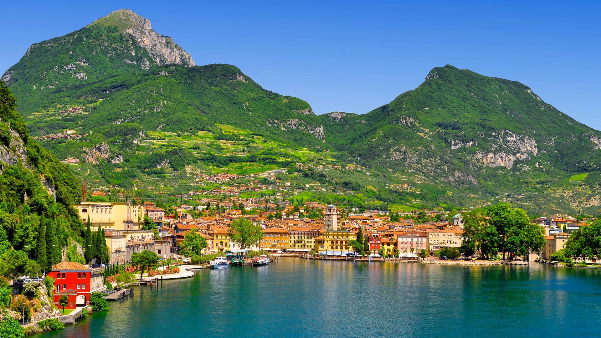 Colourful town with mountains in the background on the shore of Lake Garda