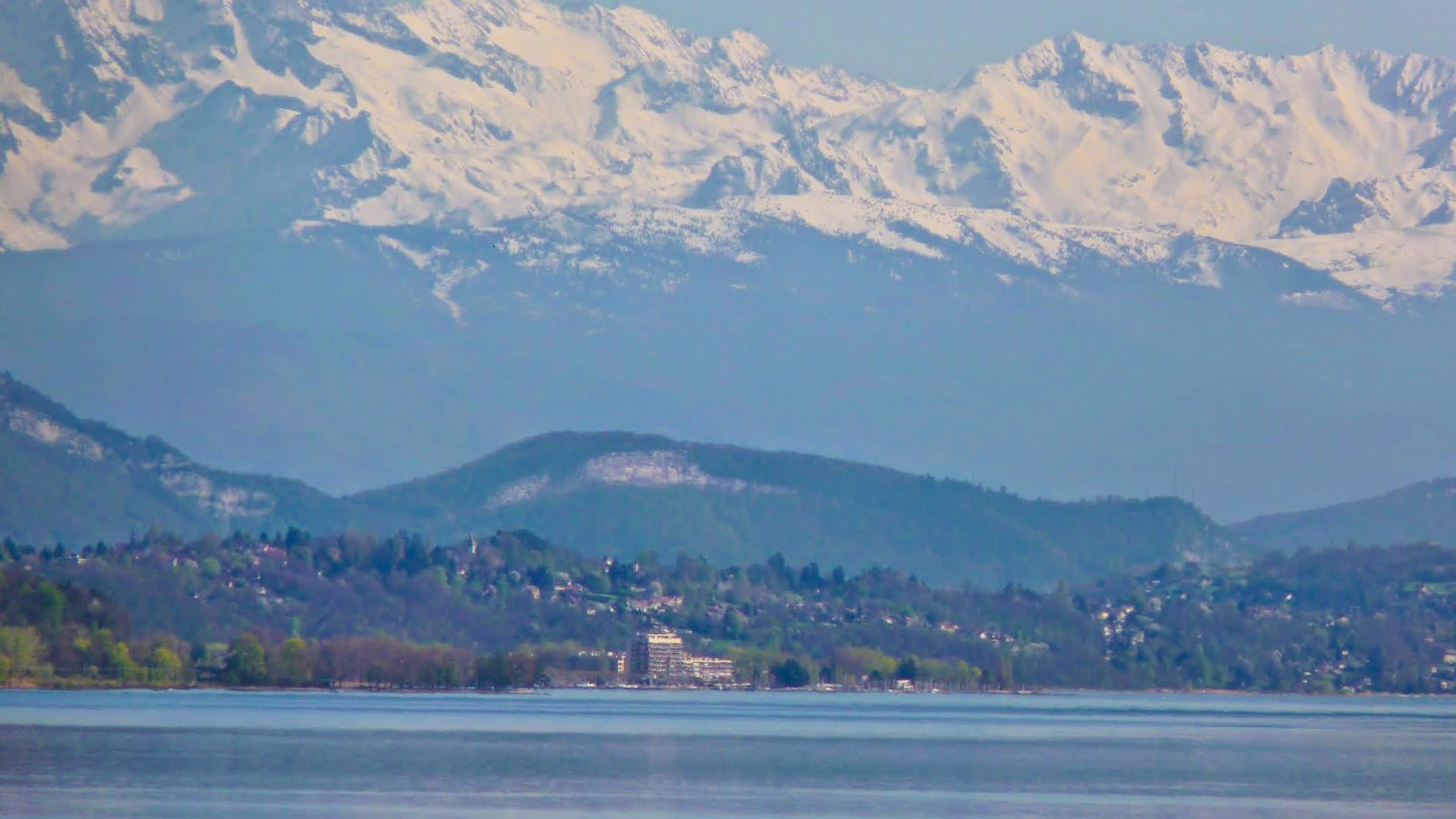 Snow-capped alpine peaks view across Lake Geneva