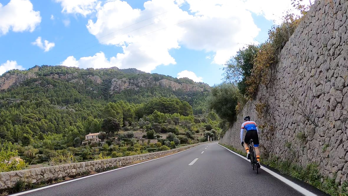 Cyclist climbing a quiet mountain road to Banyalbufar on Andratx to Pollensa cycling route MA-10 Mallorca