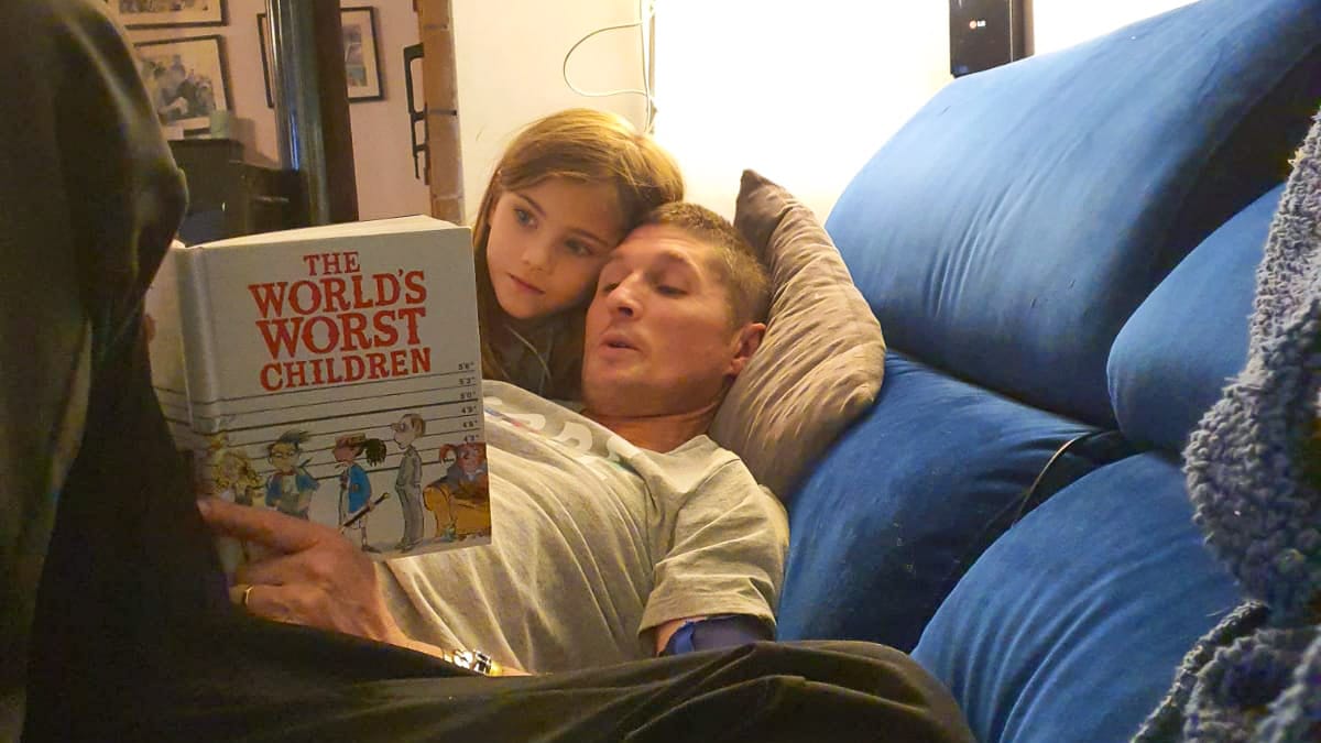 Dave from Bike Breaks Girona reading with his daughter