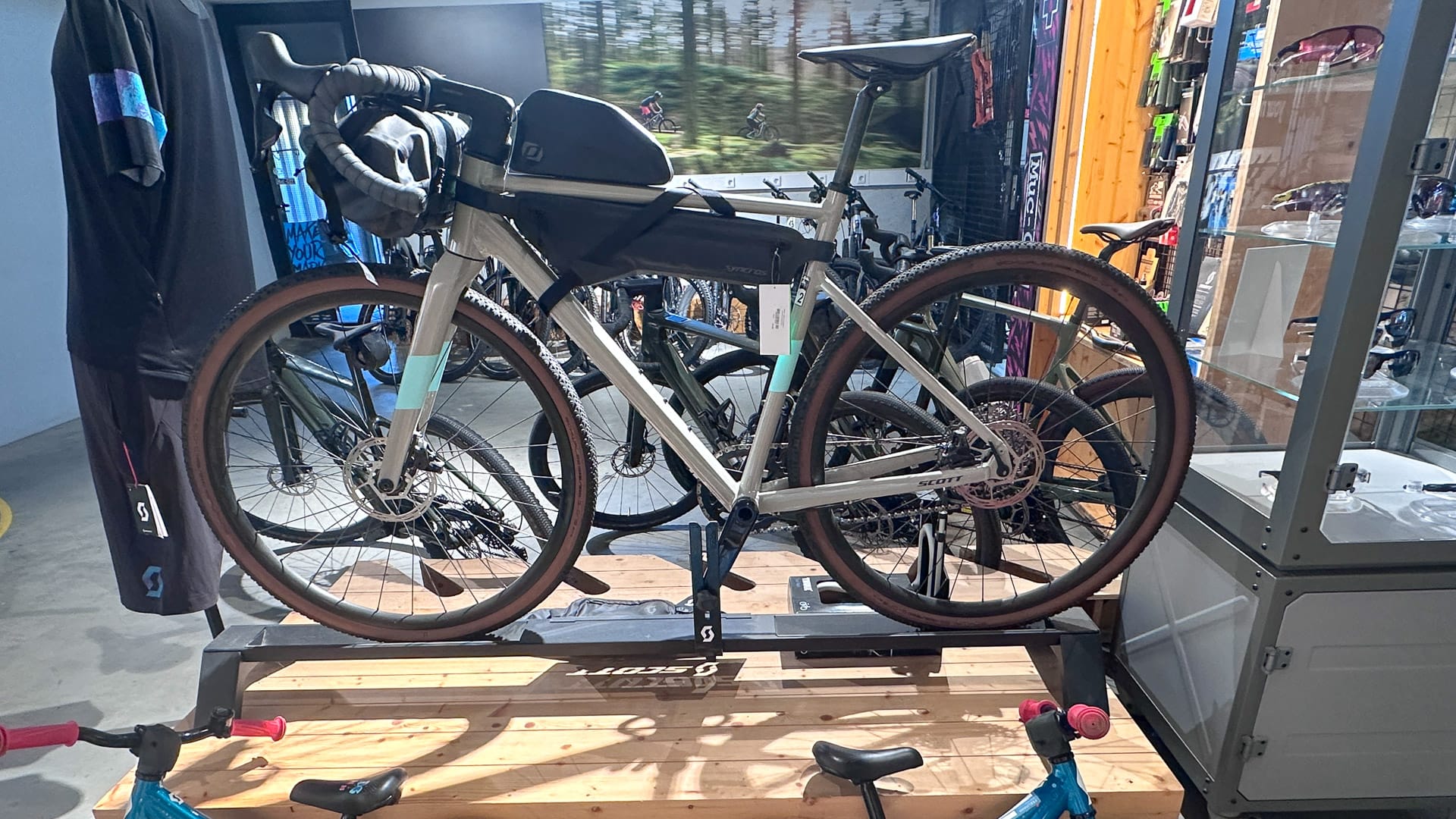 Bike hotel display of a loaded gravel bike on a wooden stand with kit around