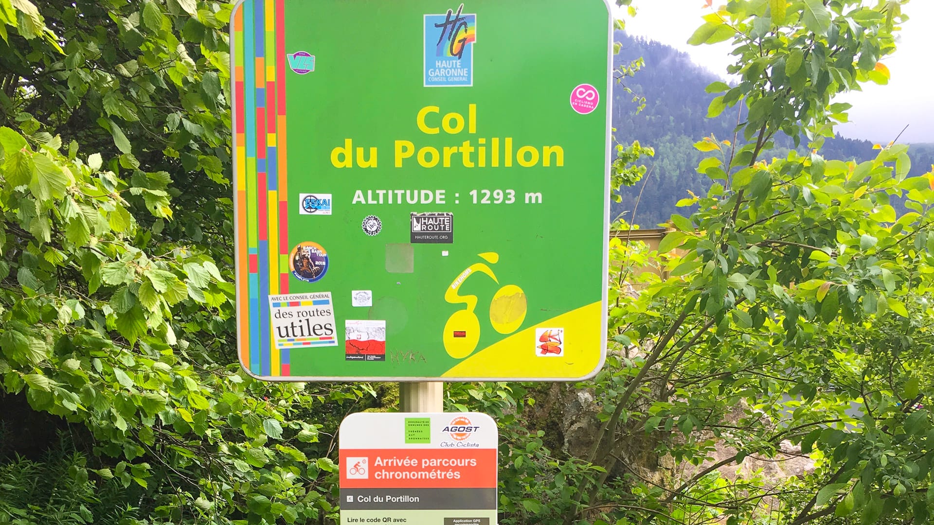 Cyclist's bike on the Col du Portillon summit sign