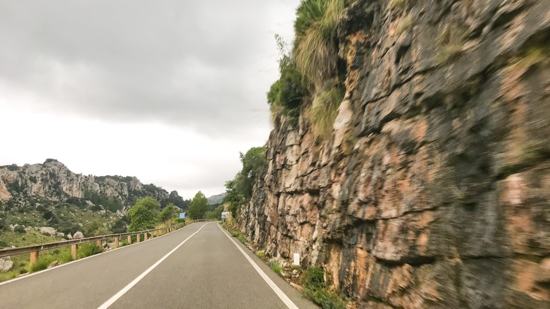 View of rocky cliffs by side of road on route of Mallorca 312
