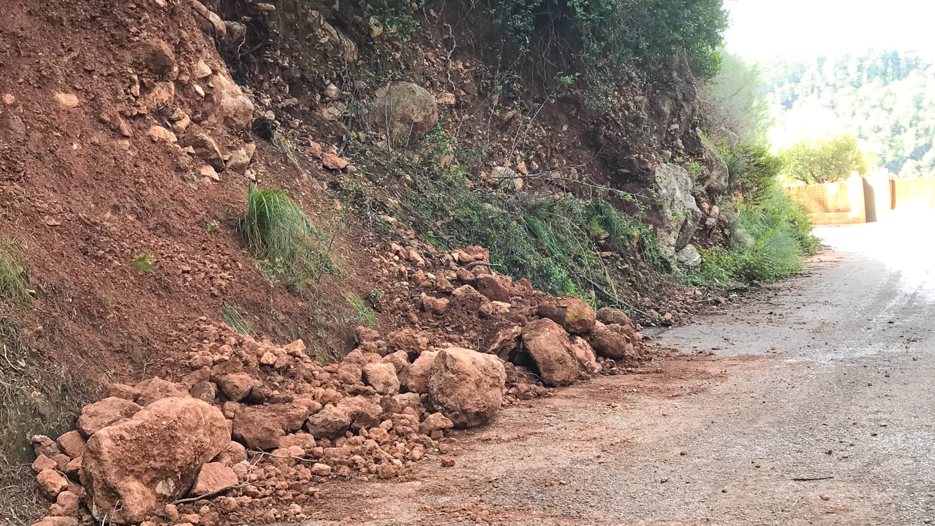 Small rockfall with loose stones and boulders on rural roadside near Port des Canonge, Mallorca