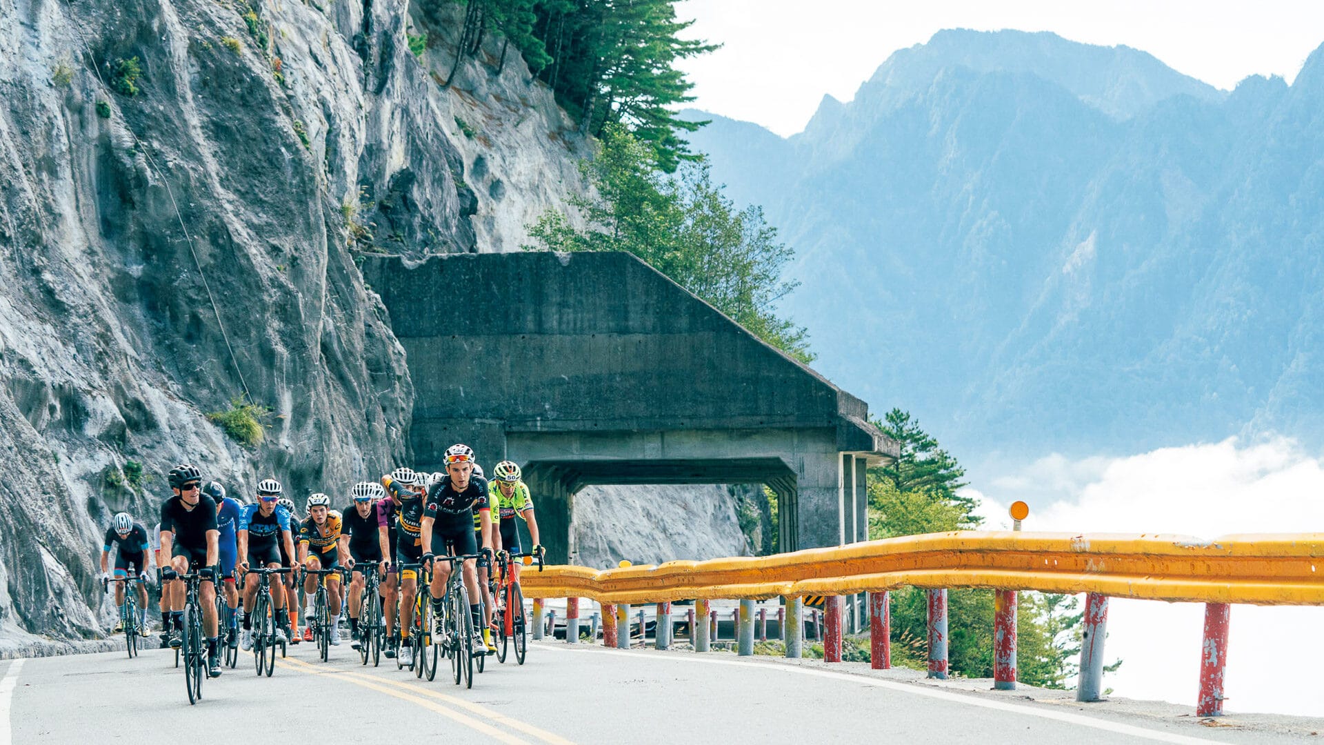 Road cyclists cycling in Taiwan's mountainous scenery