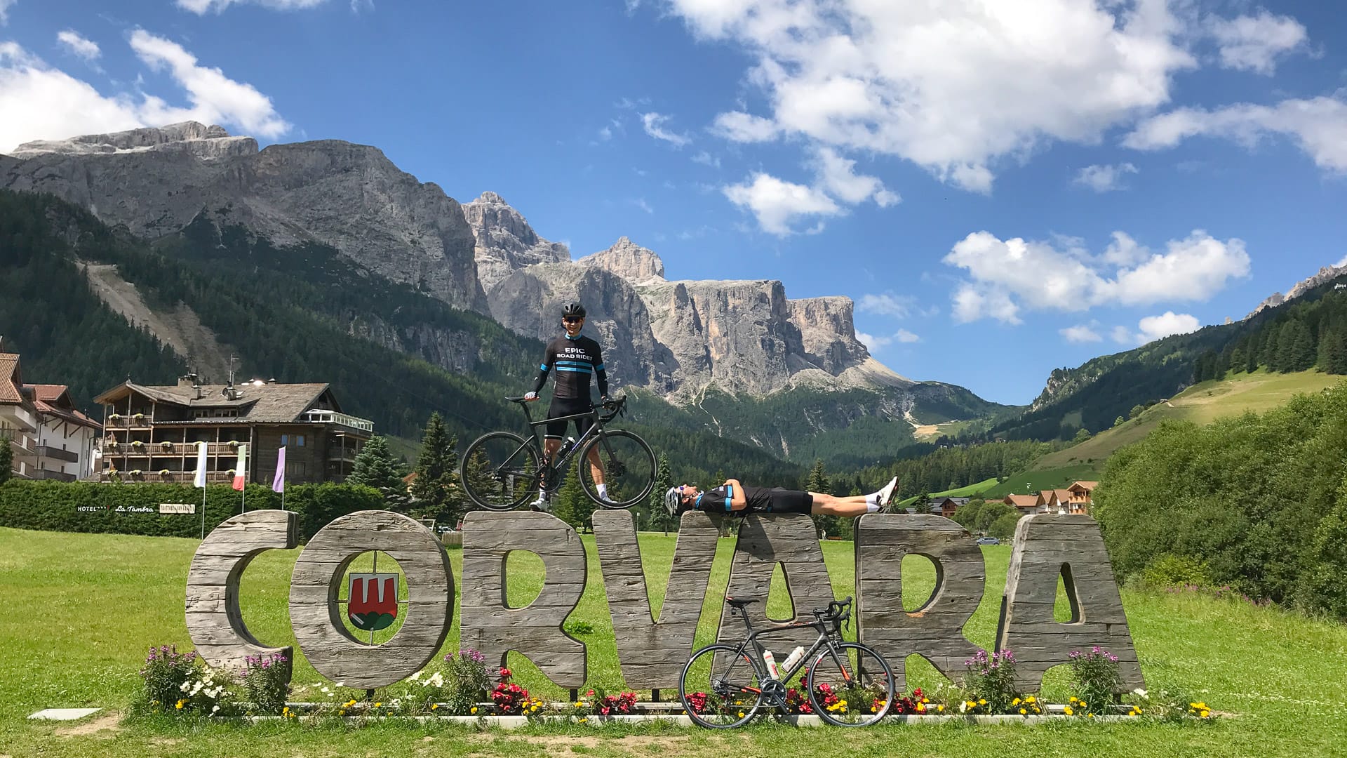 Two cyclists on Corvara sign