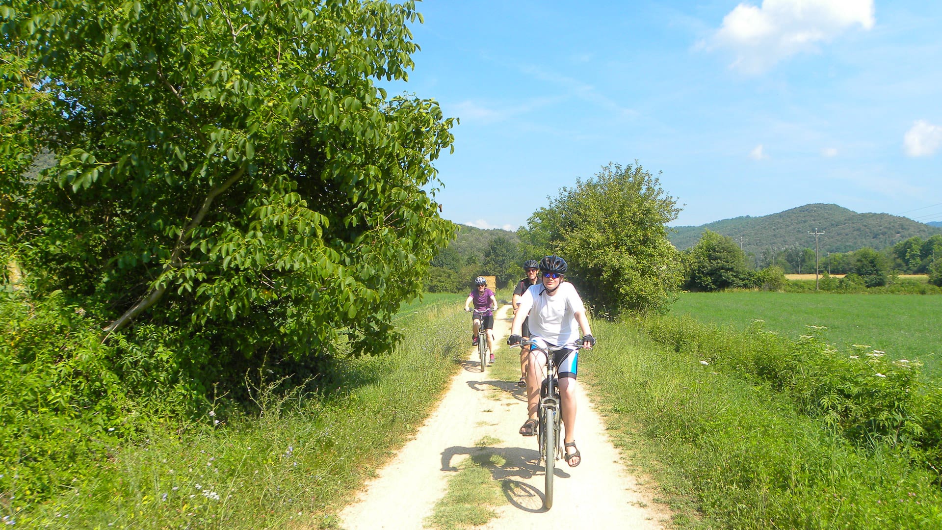 Cyclists on easy cycling routes off-road from Girona 
