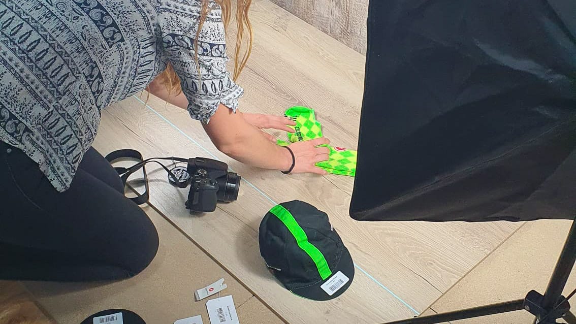 Woman taking photos of pro cycling team kit