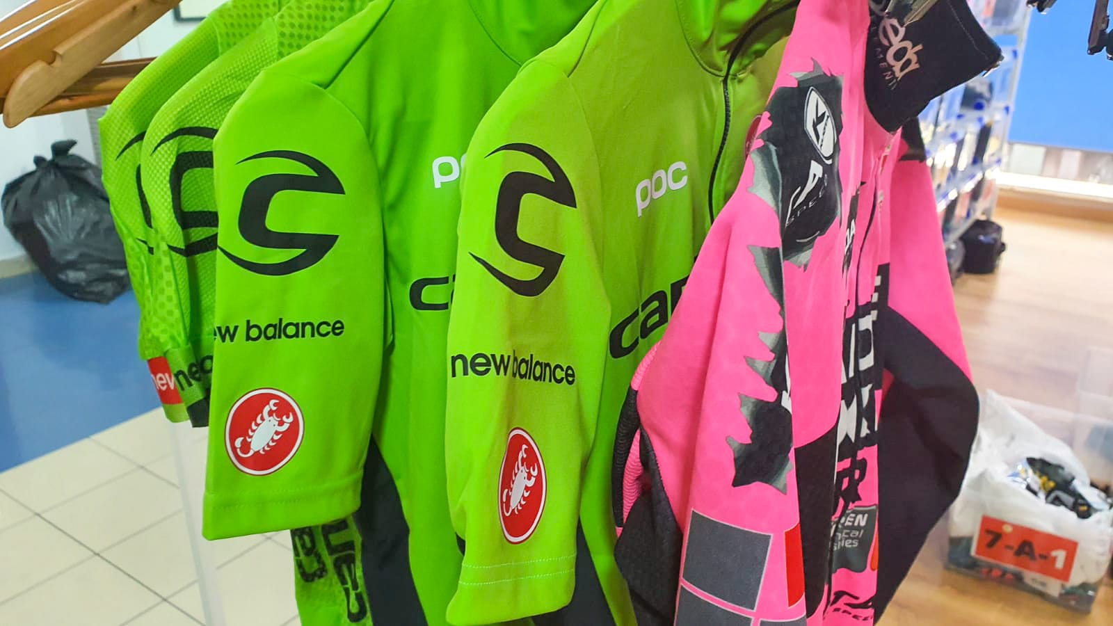 Pro team cycling jerseys in green and pink