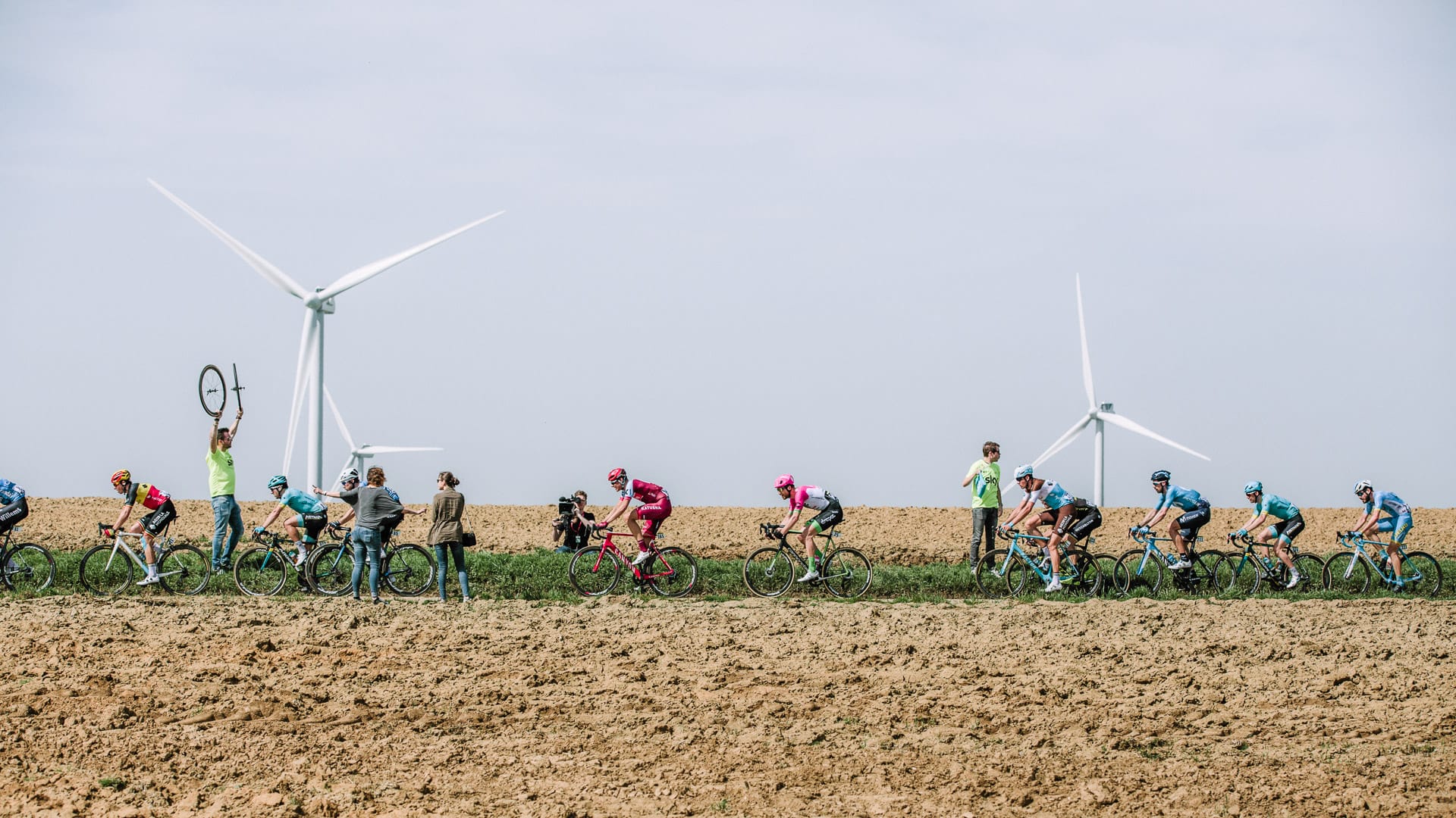 Cyclists cycling through rural terrain