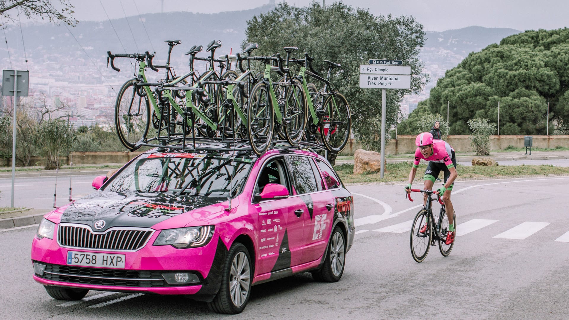 Pro cycling team car with bikes and rider behind