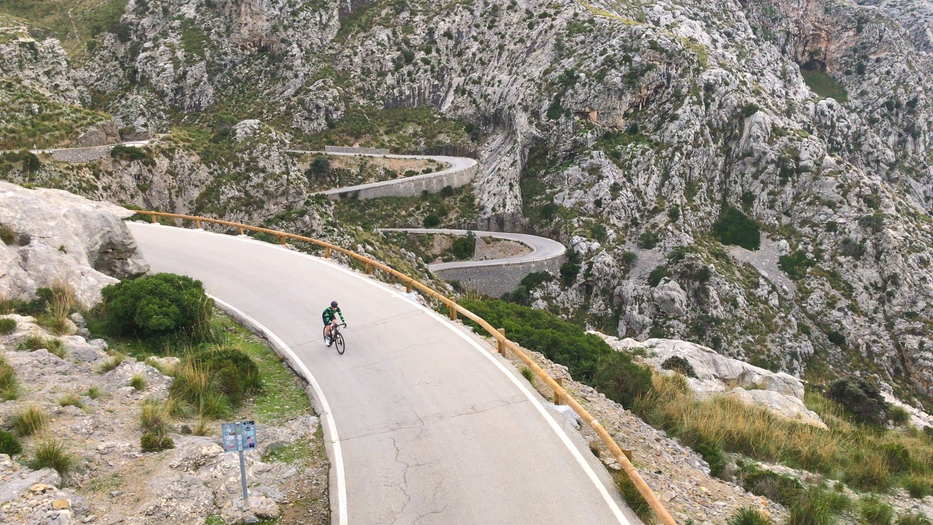 View down onto cyclist from bridge on Mallorca Sa Caobra road