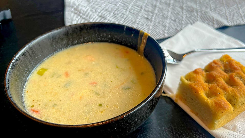 Creamy vegetable soup served with focaccia bread at a restaurant stop in Västerbotten Sweden