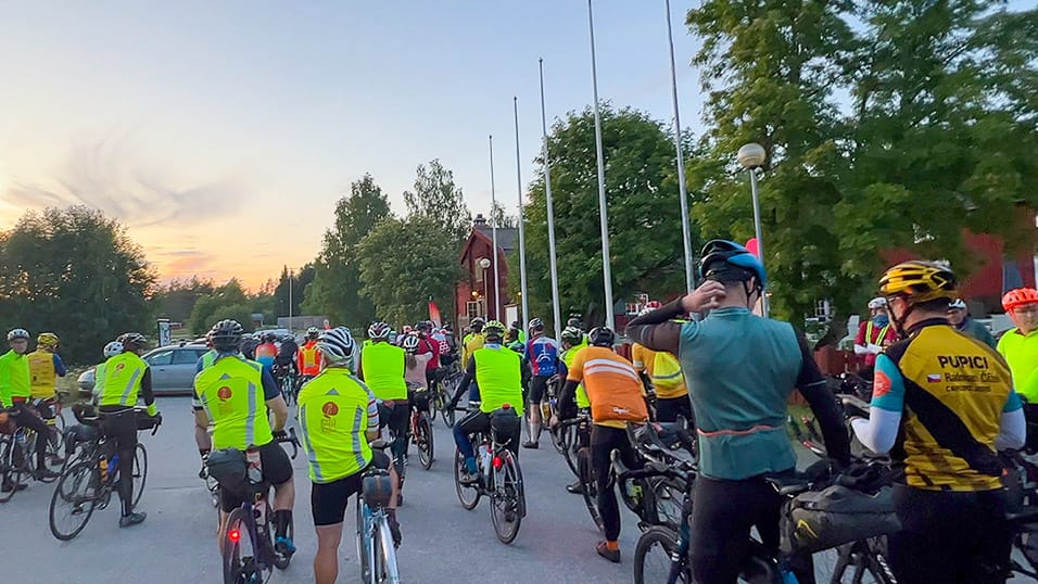 Riders gather at the Midnight Sun Randonnée start in Västerbotten Sweden, wearing bright high-vis jerseys
