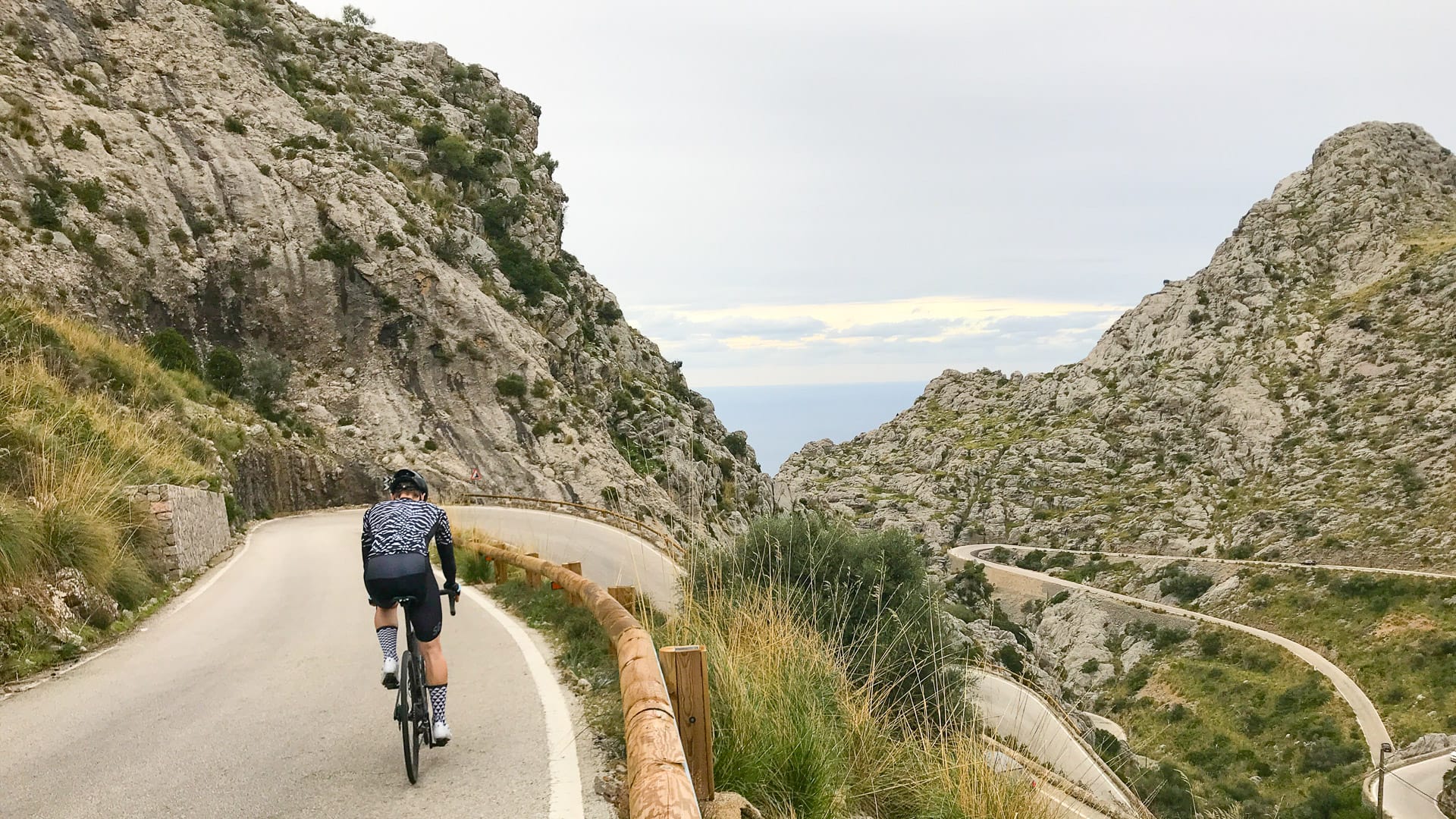 Cyclist cycling down Sa Calobra's twists and turns