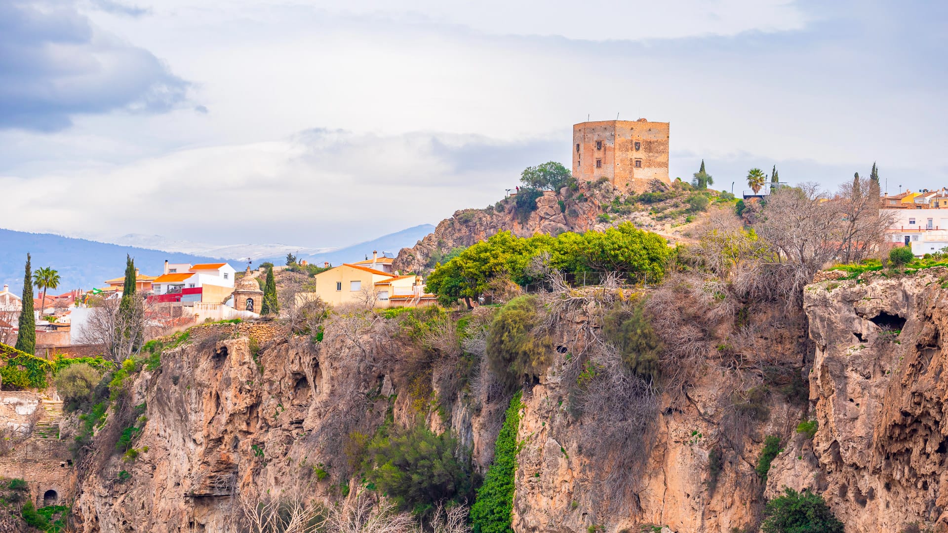 Velez de Benaudalla, in Granada, Spain, partial view of the town next to a ravine and its Moorish castle.