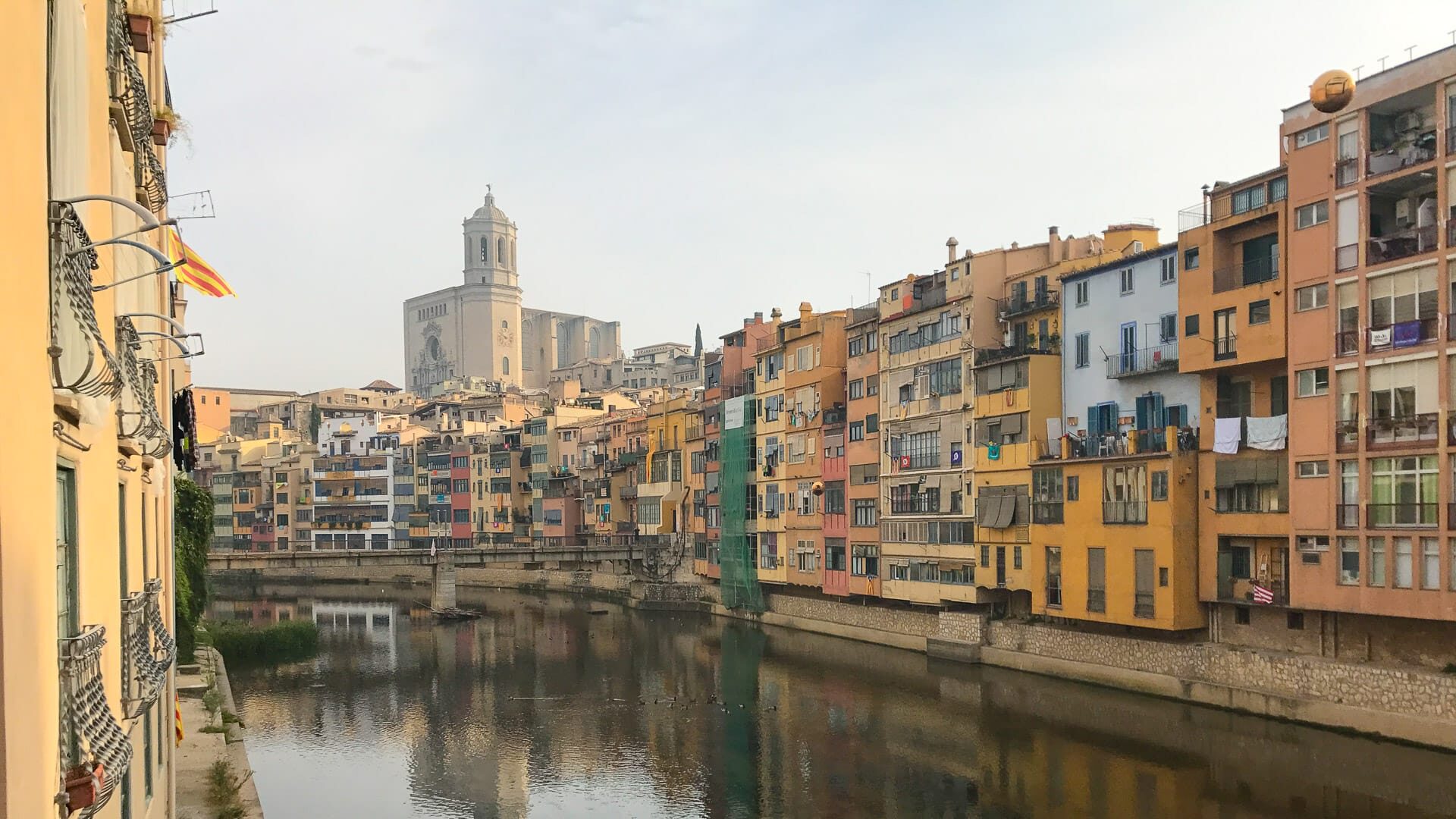 Things to do in Girona Spain: walk along the river that flows through Girona, surrounded by pastel coloured buildings