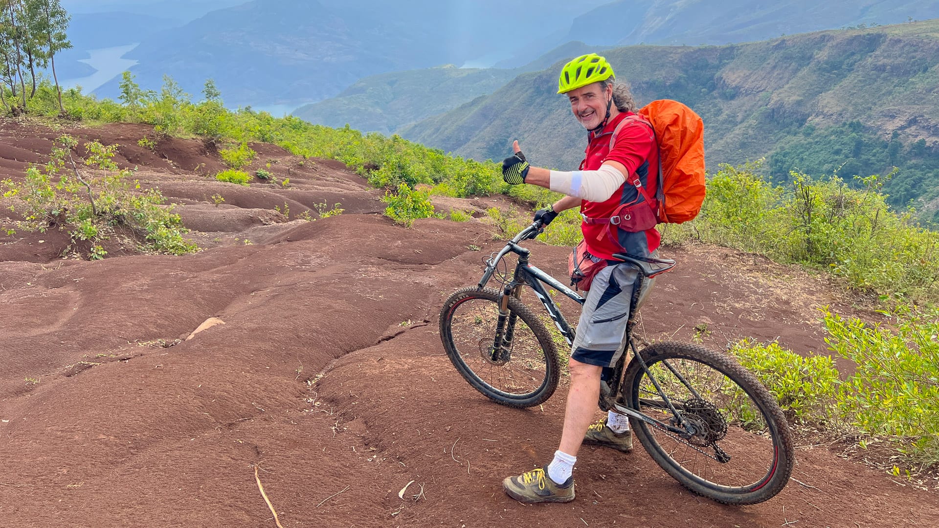 Cyclist riding across rocky terrain on a mountain bike during a cycling trip in Ethiopia